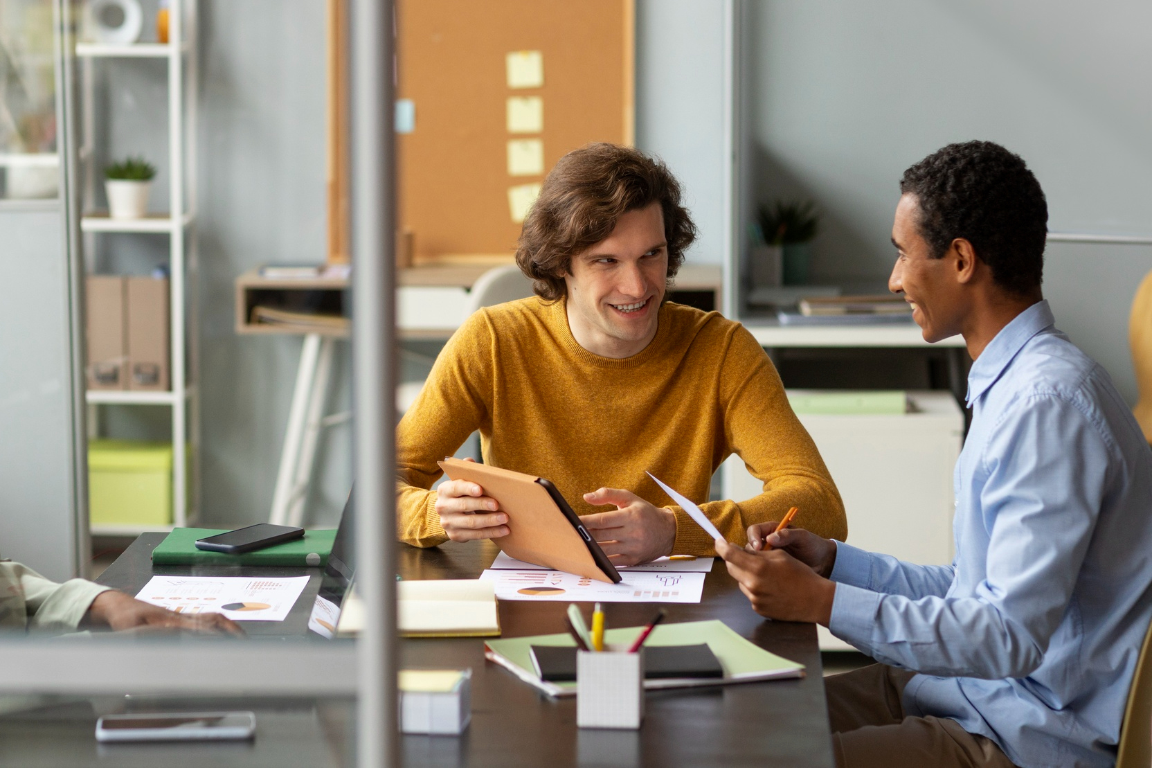 Two colleagues discussing a creative project in the studio